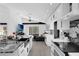 Modern kitchen features white cabinetry, stainless steel appliances, and granite countertops with island and open floorplan at 2520 Oakington St, Winter Garden, FL 34787