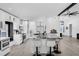 Modern kitchen with white cabinetry, black marble countertops, and sleek, stainless steel appliances at 2520 Oakington St, Winter Garden, FL 34787