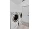 Functional laundry room featuring modern washer and dryer units and a clean white door at 2520 Oakington St, Winter Garden, FL 34787