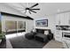 Relaxing open living room features a gray sectional sofa, neutral decor, and views of screened patio at 2520 Oakington St, Winter Garden, FL 34787