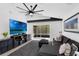 Modern living room with a large television, sleek furniture, and access to screened-in patio at 2520 Oakington St, Winter Garden, FL 34787