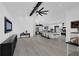 Open concept living space with modern kitchen, hardwood floors and vaulted ceilings at 2520 Oakington St, Winter Garden, FL 34787