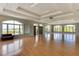 Spacious meeting room with a hardwood floor, tray ceilings, a projector, large arched windows, and a black leather sofa at 2520 Oakington St, Winter Garden, FL 34787