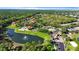 Aerial view of Emerald Island community featuring a lake, pool, entrance, and lush green landscaping at 2742 Sun Key Pl, Kissimmee, FL 34747