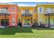 Townhome exterior with backyard patio, lush grass, and outdoor seating at 2742 Sun Key Pl, Kissimmee, FL 34747