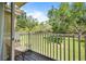 Cozy balcony with furniture overlooking a landscaped yard with trees at 2742 Sun Key Pl, Kissimmee, FL 34747