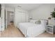 Cozy bedroom with light wood flooring, a comfortable bed, and access to a private bath at 2742 Sun Key Pl, Kissimmee, FL 34747