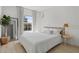 Bright bedroom featuring a queen-size bed, large window, and modern decor at 2742 Sun Key Pl, Kissimmee, FL 34747