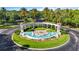 Grand entrance to Emerald Island community with beautifully landscaped roundabout, water fountain, and signage at 2742 Sun Key Pl, Kissimmee, FL 34747