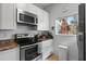 Stylish kitchen with stainless steel appliances, white cabinets, and granite countertops at 2742 Sun Key Pl, Kissimmee, FL 34747