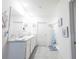 Bright bathroom features a double sink vanity, decorative accents, and tiled floor at 2752 Grand Central Ave, Tavares, FL 32778