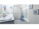 Fresh bathroom featuring double sinks, a walk-in shower, and beach-themed decor at 2752 Grand Central Ave, Tavares, FL 32778