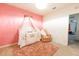 Pink Bedroom featuring a crib with canopy, accent chair and a plush rug at 2752 Grand Central Ave, Tavares, FL 32778