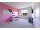 Pink accent wall in this bedroom with a desk, chair, and modern furniture at 2752 Grand Central Ave, Tavares, FL 32778