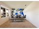 Bright dining room with a glass table, modern chairs, a bench, and an artistic accent wall at 2752 Grand Central Ave, Tavares, FL 32778