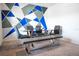 Contemporary dining room featuring a glass table, modern chairs, and an artistic accent wall at 2752 Grand Central Ave, Tavares, FL 32778