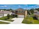 Charming two-story home with a well-manicured lawn and a two car garage at 2752 Grand Central Ave, Tavares, FL 32778