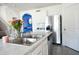 Bright kitchen features stainless steel appliances, white cabinetry, and a stylish sink with modern faucet at 2752 Grand Central Ave, Tavares, FL 32778