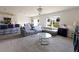 Spacious living room with comfortable seating, a large window, and a view to the backyard at 2752 Grand Central Ave, Tavares, FL 32778