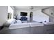 Cozy living room showcasing a plush sofa, modern decor, and staircase access at 2752 Grand Central Ave, Tavares, FL 32778