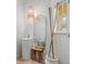 Stylish powder room features a pedestal sink, trendy light fixtures and an accent mirror at 2756 Sun Key Pl, Kissimmee, FL 34747