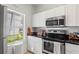 Modern kitchen features white cabinets, stainless steel appliances, and great natural light at 2756 Sun Key Pl, Kissimmee, FL 34747