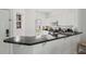 Bright kitchen with white cabinets, black countertops, and stainless steel appliances at 2756 Sun Key Pl, Kissimmee, FL 34747