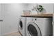 Functional laundry room with side by side washer and dryer with countertop, plus storage basket at 2756 Sun Key Pl, Kissimmee, FL 34747