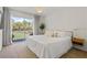 Bright main bedroom with neutral colors and view to outdoor balcony at 2756 Sun Key Pl, Kissimmee, FL 34747