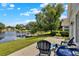 Beautiful backyard views overlooking the pond with mature trees and a patio at 2776 Joseph Cir, Oviedo, FL 32765