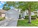 Charming home with a manicured lawn and a two-car garage, nestled under the shade of a mature tree at 2776 Joseph Cir, Oviedo, FL 32765