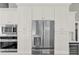 Elegant kitchen showcasing stainless steel appliances and bright white cabinetry at 2776 Joseph Cir, Oviedo, FL 32765