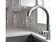 Close-up of stainless steel kitchen faucet and sink hardware with white subway tile backsplash at 2776 Joseph Cir, Oviedo, FL 32765