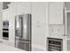 Bright kitchen features stainless steel appliances, white cabinets, and a built-in wine refrigerator at 2776 Joseph Cir, Oviedo, FL 32765