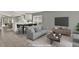 Modern staged living room flows into open concept kitchen and dining areas at 2776 Joseph Cir, Oviedo, FL 32765