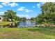 Scenic pond view surrounded by lush greenery and well-maintained lawns at 2776 Joseph Cir, Oviedo, FL 32765