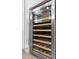 Stainless steel wine refrigerator with wooden shelves and visible wine bottles at 2776 Joseph Cir, Oviedo, FL 32765
