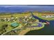 Picturesque aerial view showcasing community amenities including a lake, tennis courts and beautifully landscaped grounds at 2801 Boat Cove Cir, Kissimmee, FL 34746