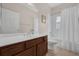 Bright bathroom with a single sink vanity, a toilet, and a shower/tub combo with a white curtain at 2801 Boat Cove Cir, Kissimmee, FL 34746