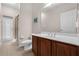 Bright bathroom with a shower, toilet, and a single sink vanity with wooden cabinets at 2801 Boat Cove Cir, Kissimmee, FL 34746