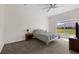 Bedroom featuring a gray bedspread, a ceiling fan, and neutral walls and flooring at 2801 Boat Cove Cir, Kissimmee, FL 34746