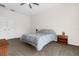 Bedroom featuring a gray bedspread, a ceiling fan, and neutral walls and flooring at 2801 Boat Cove Cir, Kissimmee, FL 34746
