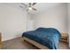 Bedroom featuring a blue bedspread, a ceiling fan, and neutral walls and flooring at 2801 Boat Cove Cir, Kissimmee, FL 34746
