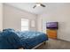 Bedroom featuring a blue bedspread, a wooden dresser, and neutral walls and flooring at 2801 Boat Cove Cir, Kissimmee, FL 34746
