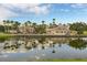 Community pool area reflecting the buildings and sky in the background at 2801 Boat Cove Cir, Kissimmee, FL 34746