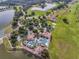 Aerial shot of luxurious community with a resort-style pool, tennis courts, lush landscaping, and scenic water views at 2801 Boat Cove Cir, Kissimmee, FL 34746