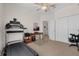 Carpeted exercise room with a treadmill and desk setup, bright ceiling fan, and neutral paint at 2801 Boat Cove Cir, Kissimmee, FL 34746