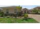Beautifully landscaped front yard with lush greenery, brick-lined flower beds, and a well-maintained lawn at 2801 Boat Cove Cir, Kissimmee, FL 34746
