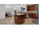 Open concept kitchen with island and bar seating flowing into living area at 2801 Boat Cove Cir, Kissimmee, FL 34746