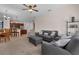 Comfortable living room with ceiling fan flows into kitchen with breakfast bar seating at 2801 Boat Cove Cir, Kissimmee, FL 34746